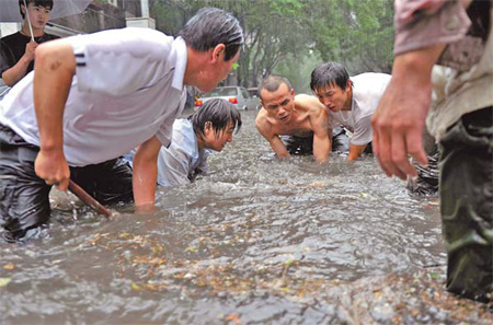 Removing manhole cover to make way for water in Beijing 2011 Removing manhole cover to make way for water in Beijing 2011
