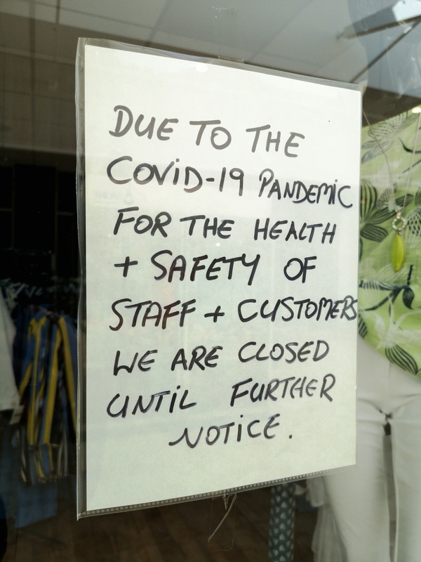 A sign in a shop window saying the shop is closed until further notice due to COVID-19 A sign in a shop window saying the shop is closed until further notice due to COVID-19