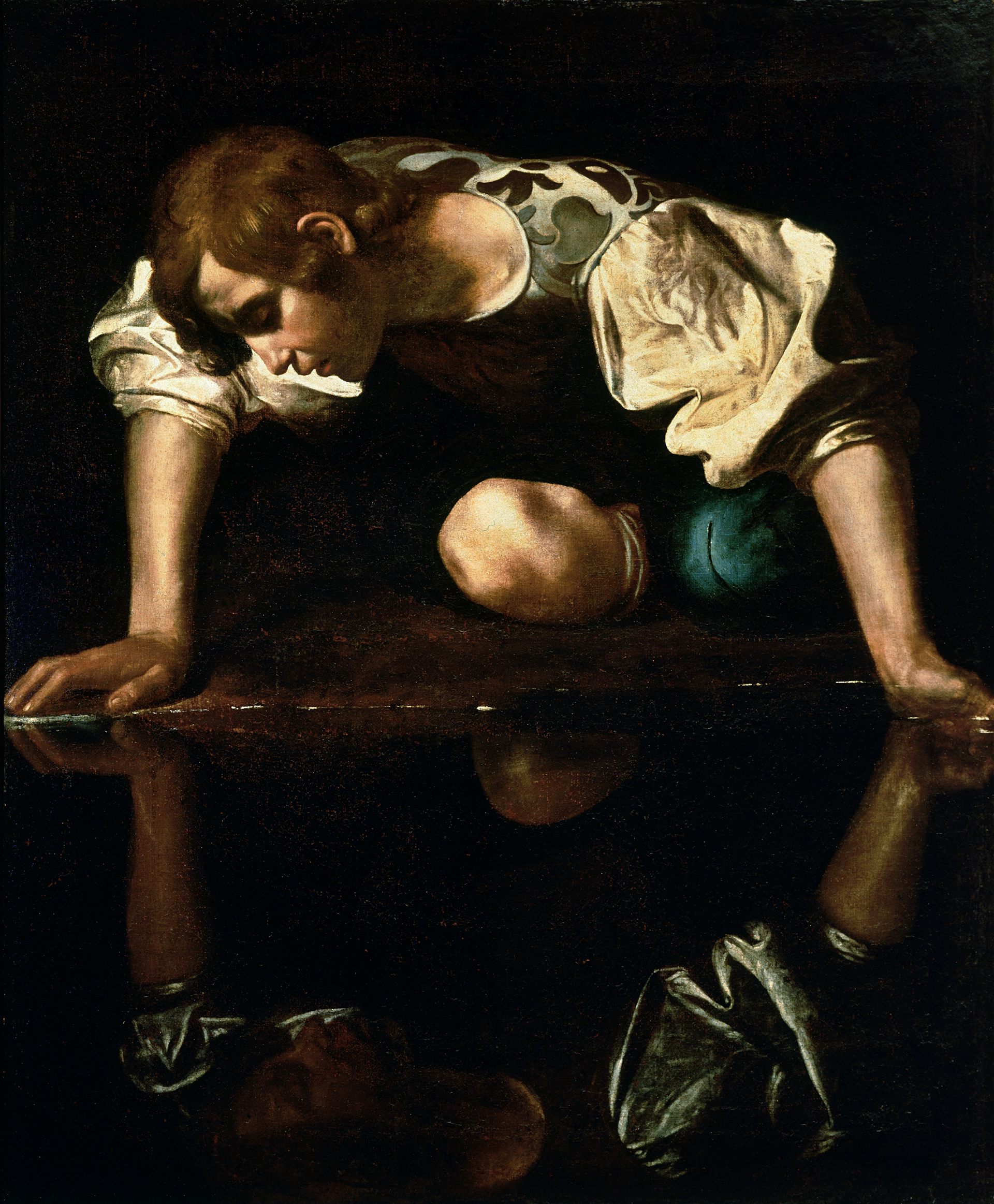 A man transfixed by his own reflection. A man transfixed by his own reflection.