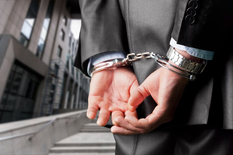 Picture of a man in handcuffs. Picture of a man in handcuffs.